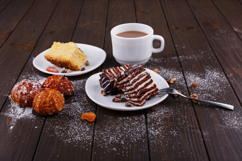 cup tea with milk two plates with cheesecake chocolate cake 8353 7334