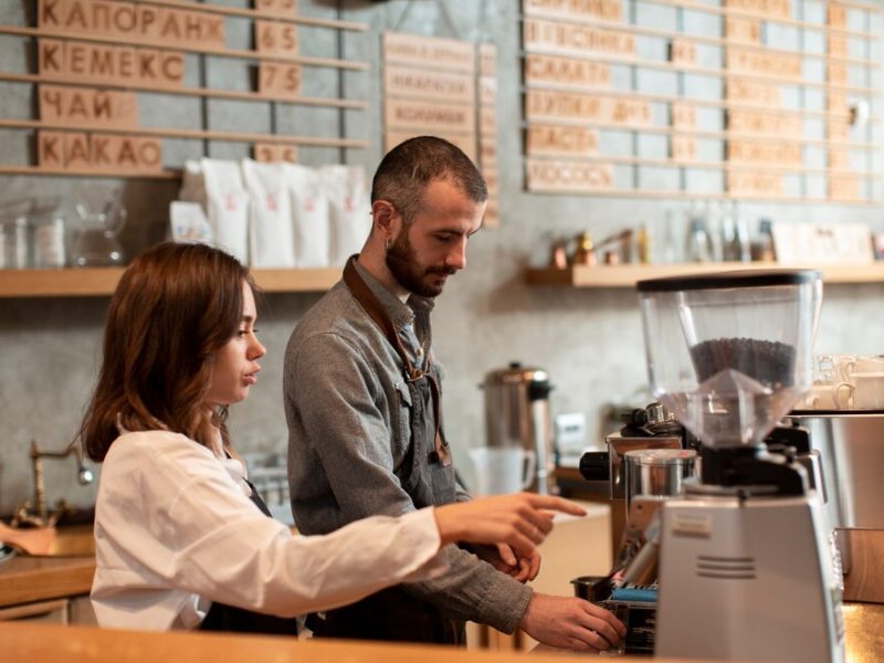 side-view-man-woman-working-coffee-shop_23-2148366652